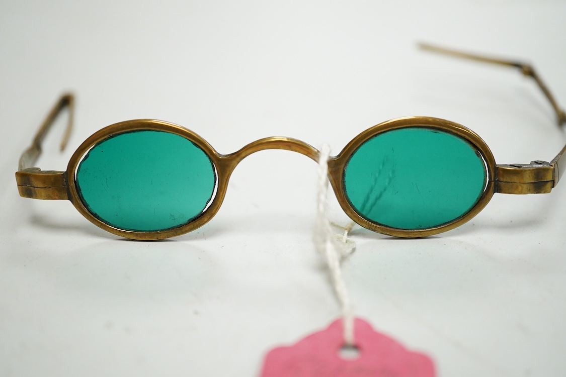 A pair of 18th century steel temple spectacles, a similar pair of iron spectacles, with written note dating them to 1796, and a pair of German? brass framed spectacles with green tinted lenses (3)